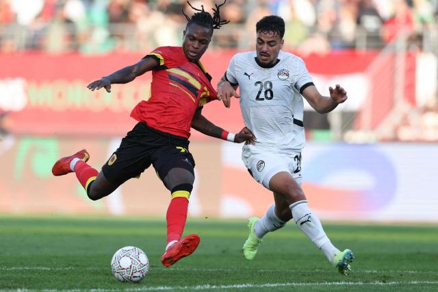 Angola's defender #27 Rui Modesto (L) fights for the ball with Egypt's defender #28 Mohamed Ismail (R) during the Africa Cup of Nations (CAN) Group B football match between Angola and Egypt at Adrar Stadium in Agadir on December 29, 2025. (Photo by FRANCK FIFE / AFP)