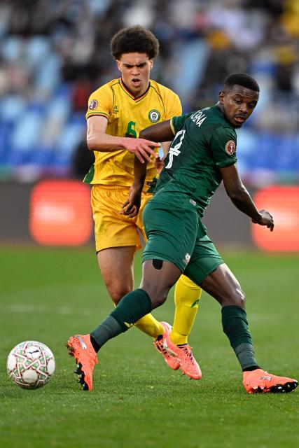 South Africa's midfielder #04 Teboho Mokoena (R) comes under pressure from Zimbabwe's midfielder #08 Jonah Fabisch during the Africa Cup of Nations (CAN) Group B football match between Zimbabwe and South Africa at Marrakesh Stadium in Marrakesh on December 29, 2025. (Photo by Khaled DESOUKI / AFP)
