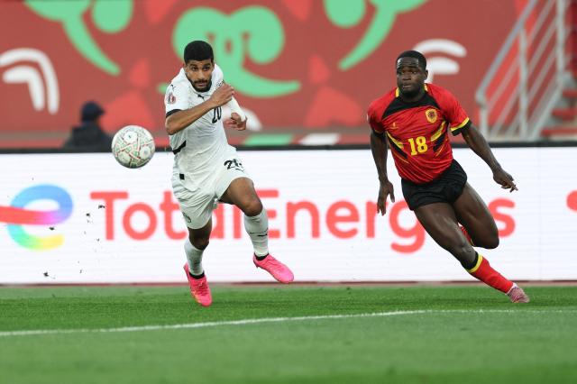 Egypt's forward #20 Ibrahim Adel (L) fights for the ball with Angola's forward #18 Zito Luvumbo (R) during the Africa Cup of Nations (CAN) Group B football match between Angola and Egypt at Adrar Stadium in Agadir on December 29, 2025. (Photo by FRANCK FIFE / AFP)
