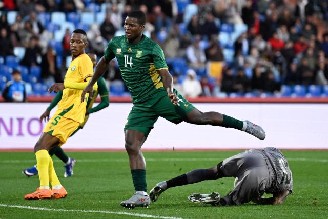 South Africa's defender #14 Mbekezeli Mbokazi jumps over South Africa's goalkeeper #22 Ricardo Goss during the Africa Cup of Nations (CAN) Group B football match between Zimbabwe and South Africa at Marrakesh Stadium in Marrakesh on December 29, 2025. (Photo by Khaled DESOUKI / AFP)