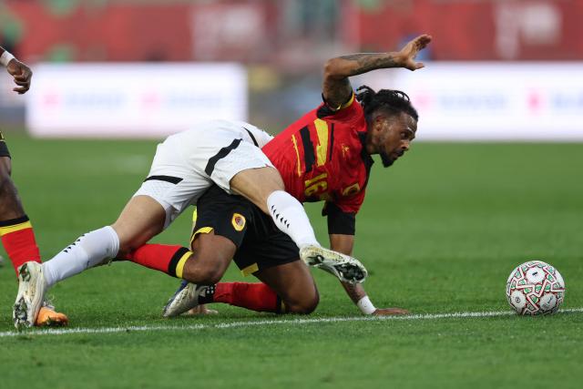 Angola's midfielder #16 Fredy (C) fights for the ball with Egypt's forward #18 Mostafa Fathi (L) during the Africa Cup of Nations (CAN) Group B football match between Angola and Egypt at Adrar Stadium in Agadir on December 29, 2025. (Photo by FRANCK FIFE / AFP)