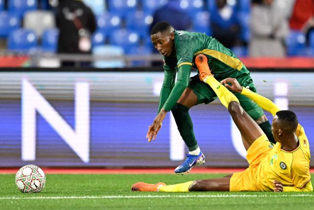 South Africa's forward #08 Tshepang Moremi (L) is tackled by Zimbabwe's defender #05 Divine Lunga during the Africa Cup of Nations (CAN) Group B football match between Zimbabwe and South Africa at Marrakesh Stadium in Marrakesh on December 29, 2025. (Photo by Khaled DESOUKI / AFP)