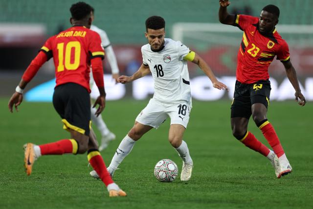 Egypt's forward #18 Mostafa Fathi (C) fights for the ball with Angola's forward #10 Gelson Dala (L) and Angola's midfielder #23 Show (R) during the Africa Cup of Nations (CAN) Group B football match between Angola and Egypt at Adrar Stadium in Agadir on December 29, 2025. (Photo by FRANCK FIFE / AFP)