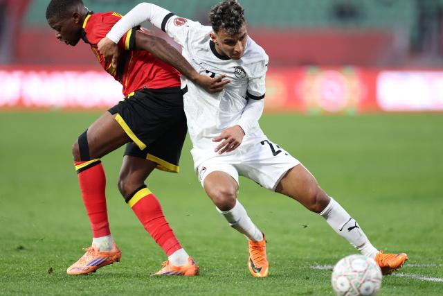 Egypt's defender #02 Khaled Sobhi (C) fights for the ball with Angola's midfielder #24 Mario Balburdia (L) during the Africa Cup of Nations (CAN) Group B football match between Angola and Egypt at Adrar Stadium in Agadir on December 29, 2025. (Photo by FRANCK FIFE / AFP)