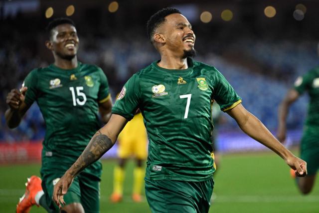 South Africa's midfielder #07 Oswin Appollis celebrates scoring the team's third goal from a penalty during the Africa Cup of Nations (CAN) Group B football match between Zimbabwe and South Africa at Marrakesh Stadium in Marrakesh on December 29, 2025. (Photo by Khaled DESOUKI / AFP)