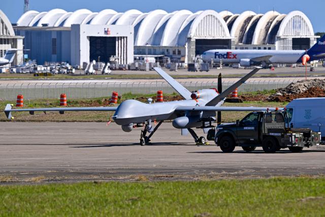 A US military MQ-9 Reaper drone sits on a tarmac at Rafael Hernandez Airport in Aguadilla, Puerto Rico, on December 29, 2025. The United States has deployed a major military force in the Caribbean and has recently intercepted oil tankers as part of a naval blockade against Venezuelan vessels it considers to be under sanctions. Since September, US forces have launched dozens of air strikes on boats that Washington alleges, without showing evidence, were transporting drugs. More than 100 people have been killed. (Photo by Miguel J. Rodriguez Carrillo / AFP)