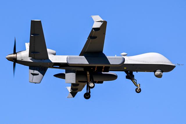 A US military MQ-9 Reaper drone approaches for landing at Rafael Hernandez Airport in Aguadilla, Puerto Rico, on December 29, 2025. The United States has deployed a major military force in the Caribbean and has recently intercepted oil tankers as part of a naval blockade against Venezuelan vessels it considers to be under sanctions. Since September, US forces have launched dozens of air strikes on boats that Washington alleges, without showing evidence, were transporting drugs. More than 100 people have been killed. (Photo by Miguel J. Rodriguez Carrillo / AFP)