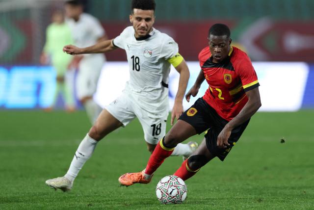 Angola's defender #02 Nurio Fortuna (R) fights for the ball with Egypt's forward #18 Mostafa Fathi (L) during the Africa Cup of Nations (CAN) Group B football match between Angola and Egypt at Adrar Stadium in Agadir on December 29, 2025. (Photo by FRANCK FIFE / AFP)