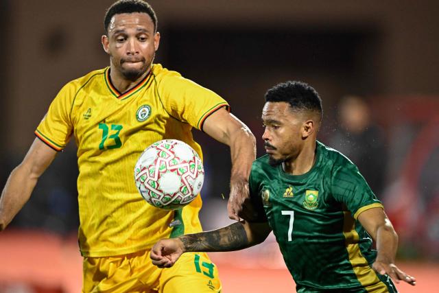 Zimbabwe's defender #13 Brendan Galloway and South Africa's midfielder #07 Oswin Appollis compete for the ball during the Africa Cup of Nations (CAN) Group B football match between Zimbabwe and South Africa at Marrakesh Stadium in Marrakesh on December 29, 2025. (Photo by Khaled DESOUKI / AFP)