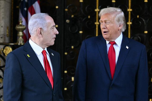 US President Donald Trump (R) greets Israeli Prime Minister Benjamin Netanyahu (L) upon arrival at Trump’s Mar-a-Lago residence in Palm Beach, Florida, on December 29, 2025. (Photo by Jim WATSON / AFP)