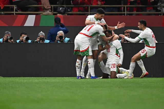 Morocco's forward #20 Ayoub El Kaabi (2nd R) celebrates scoring his team's first goal with teammates during the Africa Cup of Nations (CAN) group stage football match between Zambia and Morocco at Prince Moulay Abdellah Stadium in Rabat on December 29, 2025. (Photo by Gabriel BOUYS / AFP)
