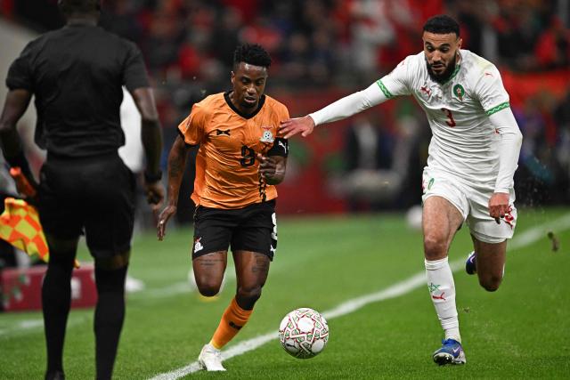 Zambia's midfielder #08 Lubambo Musonda (l) fights for the ball with Morocco's defender #03 Noussair Mazraoui (R) during the Africa Cup of Nations (CAN) group stage football match between Zambia and Morocco at Prince Moulay Abdellah Stadium in Rabat on December 29, 2025. (Photo by Gabriel BOUYS / AFP)