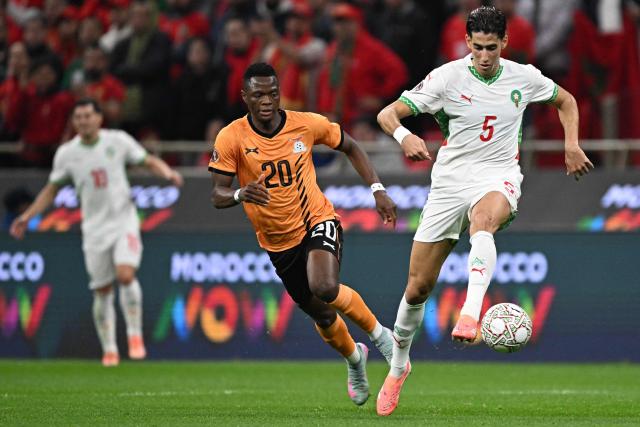 Morocco's defender #05 Nayef Aguerd fights for the ball with Zambia's forward #20 Patson Daka (C) during the Africa Cup of Nations (CAN) group stage football match between Zambia and Morocco at Prince Moulay Abdellah Stadium in Rabat on December 29, 2025. (Photo by Gabriel BOUYS / AFP)