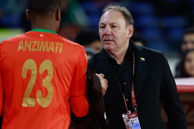 Comoros' head coach Stefano Cusin shakes hands with Comoros's goalkeeper #23 Adel Anzimati-Aboudou during the Africa Cup of Nations (CAN) Group A football match between Comoros and Mali at Mohammed V Stadium in Casablanca on December 29, 2025. (Photo by Abdel Majid BZIOUAT / AFP)