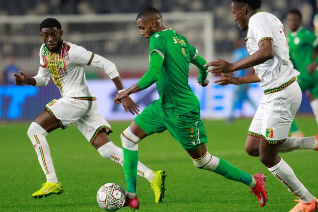 Mali's defender #13 Fode Doucoure (L) closes in on Comoros's forward #07 Faiz Selemani during the Africa Cup of Nations (CAN) Group A football match between Comoros and Mali at Mohammed V Stadium in Casablanca on December 29, 2025. (Photo by Abdel Majid BZIOUAT / AFP)