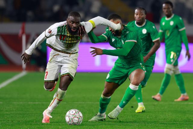 Mali's forward #17 Lassine Sinayoko (L) clashes with Comoros's defender #08 Yannis Kari  during the Africa Cup of Nations (CAN) Group A football match between Comoros and Mali at Mohammed V Stadium in Casablanca on December 29, 2025. (Photo by Abdel Majid BZIOUAT / AFP)
