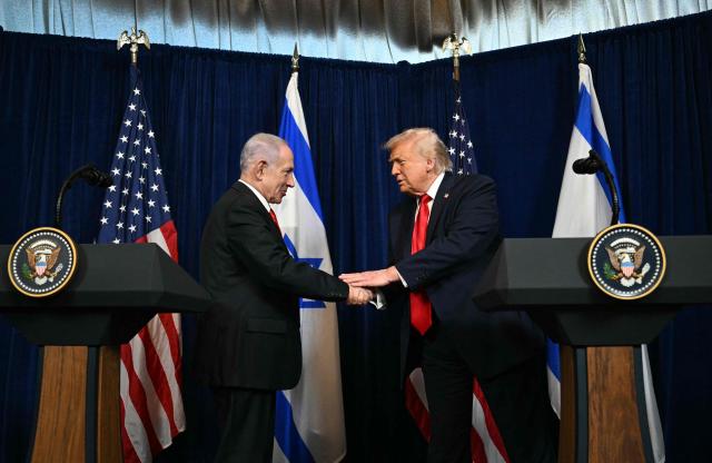 US President Donald Trump (R) and Israeli Prime Minister Benjamin Netanyahu shake hands as they arrive to speak to journalists during a joint press conference at Trumps Mar-a-Lago residence in Palm Beach, Florida, on December 29, 2025. US President Donald Trump hosted Israeli Prime Minister Benjamin Netanyahu in Florida on December 29 for crucial talks on moving to the next stage of the fragile Gaza truce plan.
The two leaders also discussed Iran, with Trump saying that if Tehran rebuilt its nuclear facilities the United States would "knock them down." (Photo by Jim WATSON / AFP)