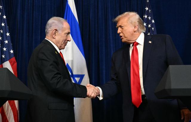 US President Donald Trump (R) and Israeli Prime Minister Benjamin Netanyahu shake hands as they arrive to speak to journalists during a joint press conference at Trumps Mar-a-Lago residence in Palm Beach, Florida, on December 29, 2025. US President Donald Trump hosted Israeli Prime Minister Benjamin Netanyahu in Florida on December 29 for crucial talks on moving to the next stage of the fragile Gaza truce plan.
The two leaders also discussed Iran, with Trump saying that if Tehran rebuilt its nuclear facilities the United States would "knock them down." (Photo by Jim WATSON / AFP)
