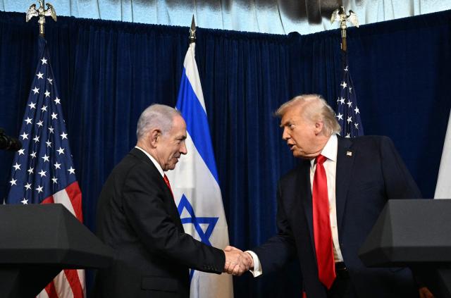 US President Donald Trump (R) and Israeli Prime Minister Benjamin Netanyahu shake hands as they arrive to speak to journalists during a joint press conference at Trumps Mar-a-Lago residence in Palm Beach, Florida, on December 29, 2025. US President Donald Trump hosted Israeli Prime Minister Benjamin Netanyahu in Florida on December 29 for crucial talks on moving to the next stage of the fragile Gaza truce plan.
The two leaders also discussed Iran, with Trump saying that if Tehran rebuilt its nuclear facilities the United States would "knock them down." (Photo by Jim WATSON / AFP)