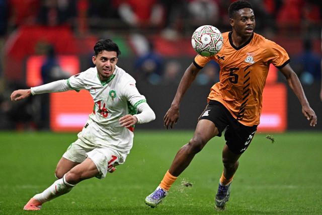 Morocco's forward #16 Ilias Akhomach (L) fights for the ball with Zambia's midfielder #05 Miguel Chaiwa (R) during the Africa Cup of Nations (CAN) group stage football match between Zambia and Morocco at Prince Moulay Abdellah Stadium in Rabat on December 29, 2025. (Photo by Gabriel BOUYS / AFP)