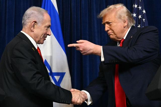 US President Donald Trump (R) and Israeli Prime Minister Benjamin Netanyahu shake hands as they arrive to speak to journalists during a joint press conference at Trumps Mar-a-Lago residence in Palm Beach, Florida, on December 29, 2025. US President Donald Trump hosted Israeli Prime Minister Benjamin Netanyahu in Florida on December 29 for crucial talks on moving to the next stage of the fragile Gaza truce plan.
The two leaders also discussed Iran, with Trump saying that if Tehran rebuilt its nuclear facilities the United States would "knock them down." (Photo by Jim WATSON / AFP)