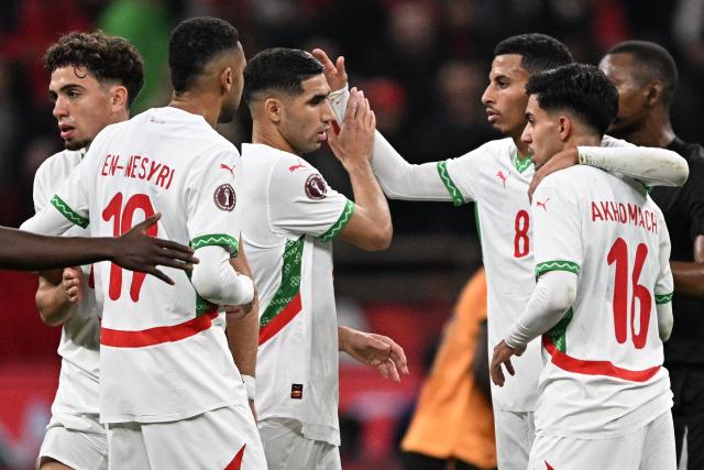 Morocco's defender #02 Achraf Hakimi (3rd L) celebrates with Morocco's midfielder #08 Azzedine Ounahi (2nd R) and Morocco's forward #16 Ilias Akhomach (R) during the Africa Cup of Nations (CAN) group stage football match between Zambia and Morocco at Prince Moulay Abdellah Stadium in Rabat on December 29, 2025. (Photo by Gabriel BOUYS / AFP)