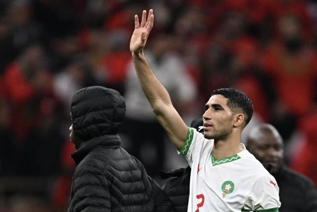Morocco's defender #02 Achraf Hakimi (R) cheers supporters at the end of the Africa Cup of Nations (CAN) group stage football match between Zambia and Morocco at Prince Moulay Abdellah Stadium in Rabat on December 29, 2025. (Photo by Gabriel BOUYS / AFP)