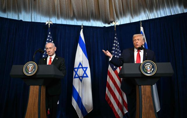 Israeli Prime Minister Benjamin Netanyahu (L) looks on as US President Donald Trump speaks to journalists during a joint press conference at Trumps Mar-a-Lago residence in Palm Beach, Florida, on December 29, 2025. US President Donald Trump hosted Israeli Prime Minister Benjamin Netanyahu in Florida on December 29 for crucial talks on moving to the next stage of the fragile Gaza truce plan.
The two leaders also discussed Iran, with Trump saying that if Tehran rebuilt its nuclear facilities the United States would "knock them down." (Photo by Jim WATSON / AFP)