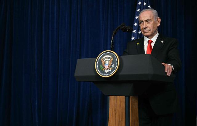 Israeli Prime Minister Benjamin Netanyahu speaks during a joint press conference with US President Donald Trump (off frame) at Trump’s Mar-a-Lago residence in Palm Beach, Florida, on December 29, 2025. US President Donald Trump hosted Israeli Prime Minister Benjamin Netanyahu in Florida on December 29 for crucial talks on moving to the next stage of the fragile Gaza truce plan.
The two leaders also discussed Iran, with Trump saying that if Tehran rebuilt its nuclear facilities the United States would "knock them down." (Photo by Jim WATSON / AFP)