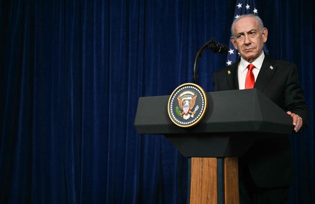 Israeli Prime Minister Benjamin Netanyahu speaks during a joint press conference with US President Donald Trump (off frame) at Trump’s Mar-a-Lago residence in Palm Beach, Florida, on December 29, 2025. US President Donald Trump hosted Israeli Prime Minister Benjamin Netanyahu in Florida on December 29 for crucial talks on moving to the next stage of the fragile Gaza truce plan.
The two leaders also discussed Iran, with Trump saying that if Tehran rebuilt its nuclear facilities the United States would "knock them down." (Photo by Jim WATSON / AFP)