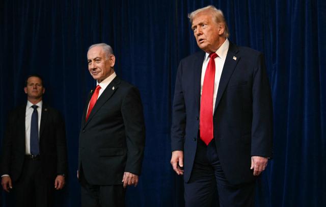 A member of the Secret Service (L) looks on as US President Donald Trump (R) and Israeli Prime Minister Benjamin Netanyahu (C) leave at the conclusion of a joint press conference at Trumps Mar-a-Lago residence in Palm Beach, Florida, on December 29, 2025. US President Donald Trump hosted Israeli Prime Minister Benjamin Netanyahu in Florida on December 29 for crucial talks on moving to the next stage of the fragile Gaza truce plan.
The two leaders also discussed Iran, with Trump saying that if Tehran rebuilt its nuclear facilities the United States would "knock them down." (Photo by Jim WATSON / AFP)