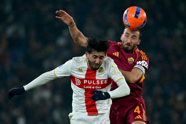 Roma's Italian midfielder #04 Bryan Cristante (R) vies with Icelandic midfielder #77 Mikael Ellertsson (L) during the Italian Serie A football match between AS Roma and Genoa at the Olympic Stadium in Rome on December 29, 2025. (Photo by Filippo MONTEFORTE / AFP)