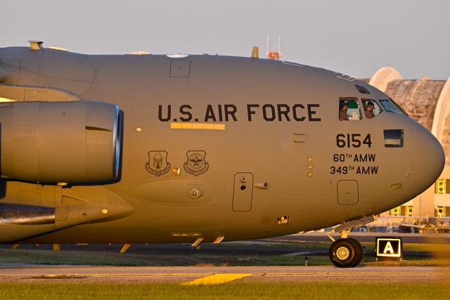 A Boeing C-17 Globemaster taxis on a tarmac at Rafael Hernandez Airport in Aguadilla, Puerto Rico, on December 29, 2025. The United States has deployed a major military force in the Caribbean and has recently intercepted oil tankers as part of a naval blockade against Venezuelan vessels it considers to be under sanctions. Since September, US forces have launched dozens of air strikes on boats that Washington alleges, without showing evidence, were transporting drugs. More than 100 people have been killed. (Photo by Miguel J. Rodriguez Carrillo / AFP)