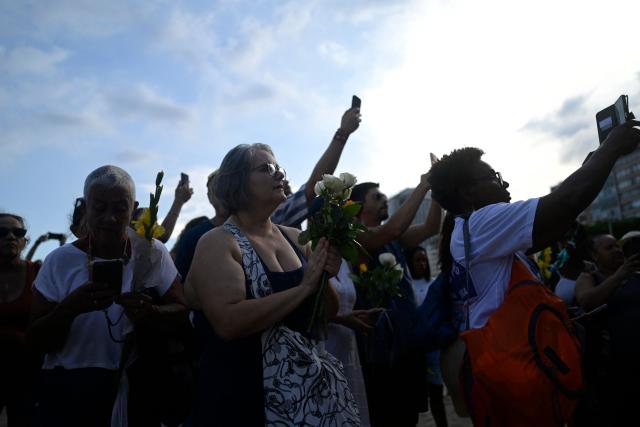 Worshippers pay tribute to Iemanja, the sea goddess of the Afro-Brazilian Umbanda religion, at Copacabana Beach in Rio de Janeiro, Brazil, on December 29, 2025. (Photo by MAURO PIMENTEL / AFP)