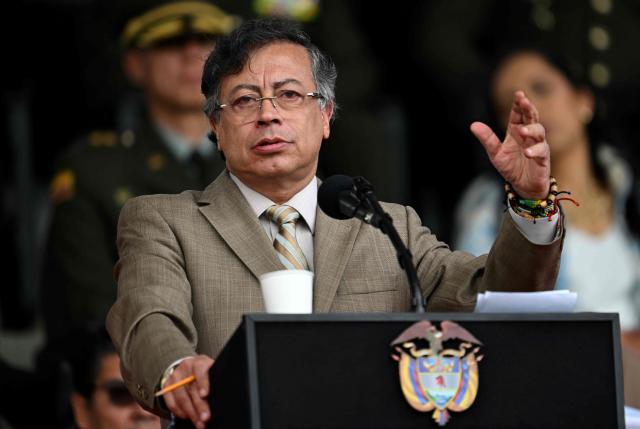 (FILES) Colombia's President Gustavo Petro delivers a speech during the commemoration of the 134th anniversary of the National Police and the promotion of officers at the General Santander Police Academy in Bogota on November 13, 2025. Colombian President Gustavo Petro, a left-wing leader, announced on December 29, a historic 23.7% increase in the minimum wage for 2026, the largest of this century, (Photo by Raul ARBOLEDA / AFP)