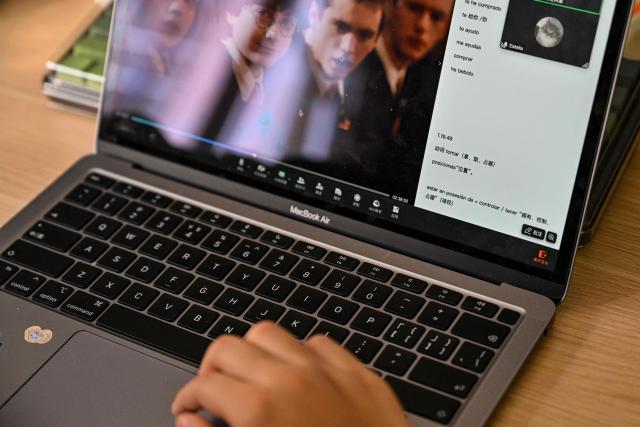 Estella, 14, a homeschooled student, attends a Spanish class in her home in Shanghai on November 25, 2025. They are among a small number of parents in China who are rethinking the country's rigorous education system, in which school days can last 10 hours, with students often working late into the evening on extra tutoring and homework. (Photo by Hector RETAMAL / AFP) / TO GO WITH: China-education-children-family, FOCUS by Mary YANG