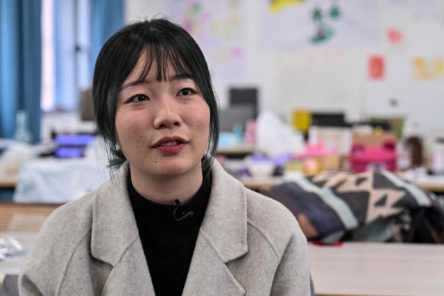 Gong Yimei, 24, formerly homeschooled student, speaks during an interview with AFP in Lishui, in eastern China's Zhejiang province on November 26, 2025. They are among a small number of parents in China who are rethinking the country's rigorous education system, in which school days can last 10 hours, with students often working late into the evening on extra tutoring and homework. (Photo by Hector RETAMAL / AFP) / TO GO WITH: China-education-children-family, FOCUS by Mary YANG