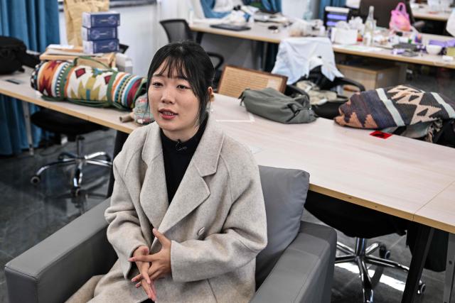 Gong Yimei, 24, formerly homeschooled student, speaks during an interview with AFP in Lishui, in eastern China's Zhejiang province on November 26, 2025. They are among a small number of parents in China who are rethinking the country's rigorous education system, in which school days can last 10 hours, with students often working late into the evening on extra tutoring and homework. (Photo by Hector RETAMAL / AFP) / TO GO WITH: China-education-children-family, FOCUS by Mary YANG