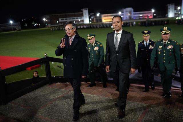Colombia’s President Gustavo Petro (L) waves next to Minister of Defense Pedro Sanchez  during a military ceremony to introduce the new commanders of the Armed Forces in Bogota on December 29, 2025. (Photo by Sergio Yate / AFP)