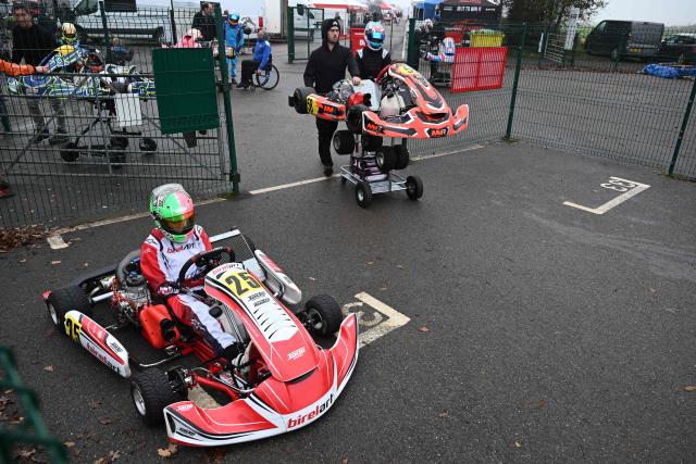 This photo taken on November 15, 2025 shows 15-year-old Skye Parker (L) during a day out at the Shenington Kart Racing Club track in Shenington, central England. A dozen girls whizzed around an English karting track, part of a pioneering drive to draw women into motorsports and maybe even race to the top in male-dominated Formula 1. (Photo by Paul ELLIS / AFP)