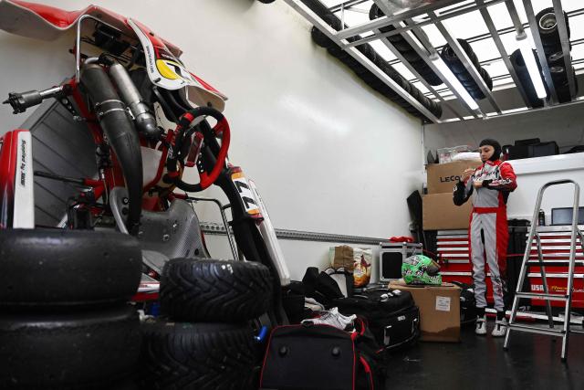 This photo taken on November 15, 2025 shows 15-year-old Skye Parker preparing for a day out at the Shenington Kart Racing Club track in Shenington, central England. A dozen girls whizzed around an English karting track, part of a pioneering drive to draw women into motorsports and maybe even race to the top in male-dominated Formula 1. (Photo by Paul ELLIS / AFP)