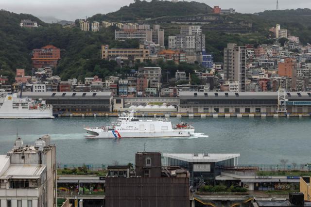 Taiwanese Coast Guard Administration (CGA) vessel Su'ao (CG612) sails at the Keelung Harbour in Keelung on December 30, 2025, amid Chinese military drills around Taiwan. China launched missiles and deployed dozens of fighter aircraft and navy vessels around Taiwan on December 30 for a second day of live-fire drills aimed at simulating a blockade of the self-ruled island's key ports and assaults on maritime targets. (Photo by CHENG Yu-chen / AFP)