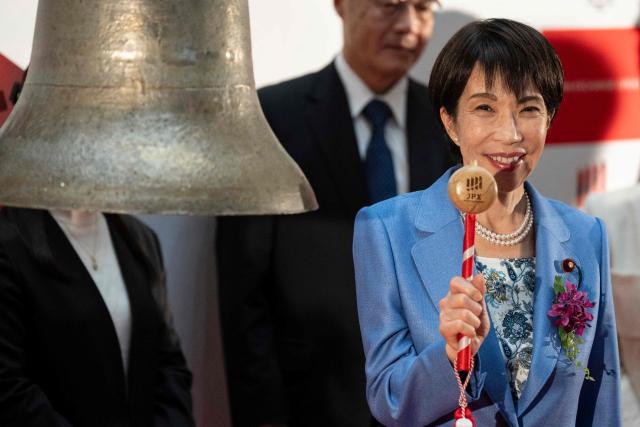 Japan’s Prime Minister Sanae Takaichi poses during a ceremony to mark the closure of the end-of-year trading session at the Tokyo Stock Exchange (TSE) in Tokyo on December 30, 2025. (Photo by Yuichi YAMAZAKI / AFP)