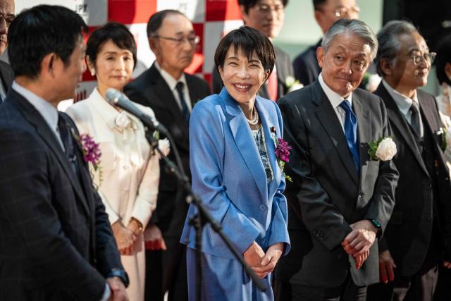 Japan’s Prime Minister Sanae Takaichi (C) attends a ceremony to mark the closure of the end-of-year trading session at the Tokyo Stock Exchange (TSE) in Tokyo on December 30, 2025. (Photo by Yuichi YAMAZAKI / AFP)