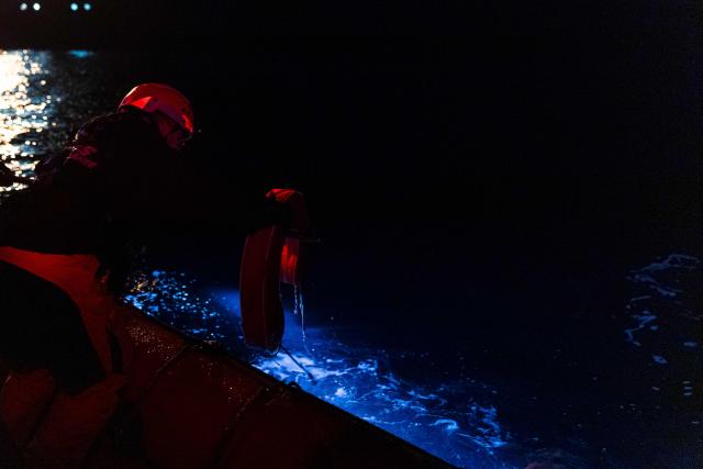 Crew members of the “Ocean Viking” rescue ship, operated by the French NGO SOS Mediterranee, take part in a team night exercise to prepare for a rescue situation at sea with a "RHIB", an inflatable dinghy, on their way to the search-and-rescue zone in international waters in the Mediterranean Sea, on December 29, 2025. Migrants rescue ship "Ocean Viking" is preparing to return to operations following the attack it suffered on August 24, 2025 when Libyan Coast Guard forces fired directly on the rescue vessel operated by the NGO SOS Mediterranee. (Photo by Sameer Al-DOUMY / AFP)