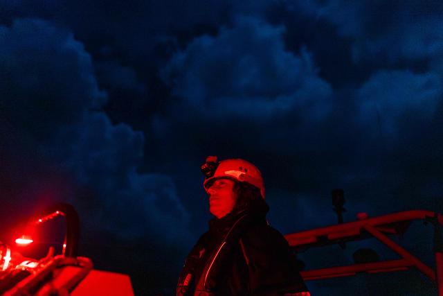 A crew member of the “Ocean Viking” rescue ship, operated by the French NGO SOS Mediterranee, takes part in a team night exercise to prepare for a rescue situation at sea with a "RHIB", an inflatable dinghy, on their way to the search-and-rescue zone in international waters in the Mediterranean Sea, on December 29, 2025. Migrants rescue ship "Ocean Viking" is preparing to return to operations following the attack it suffered on August 24, 2025 when Libyan Coast Guard forces fired directly on the rescue vessel operated by the NGO SOS Mediterranee. (Photo by Sameer Al-DOUMY / AFP)
