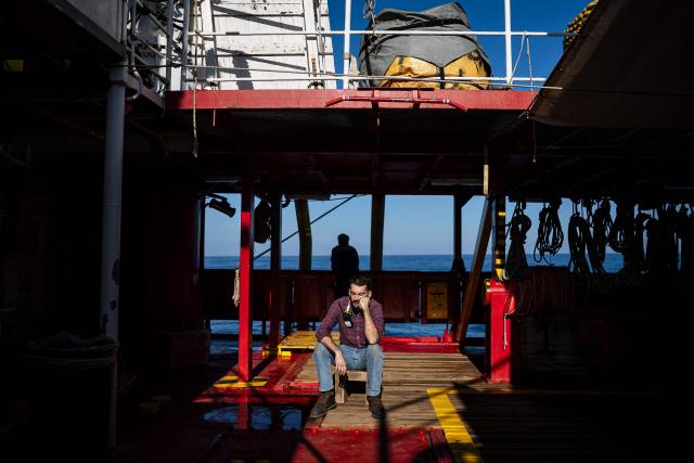A crew member of the “Ocean Viking” rescue ship, operated by the French NGO SOS Mediterranee, takes part in a team exercise to prepare for a rescue situation at sea with a "RHIB", an inflatable dinghy, on their way to the search-and-rescue zone in international waters in the Mediterranean Sea, on December 28, 2025. Migrants rescue ship "Ocean Viking" is preparing to return to operations following the attack it suffered on August 24, 2025 when Libyan Coast Guard forces fired directly on the rescue vessel operated by the NGO SOS Mediterranee. (Photo by Sameer Al-DOUMY / AFP)