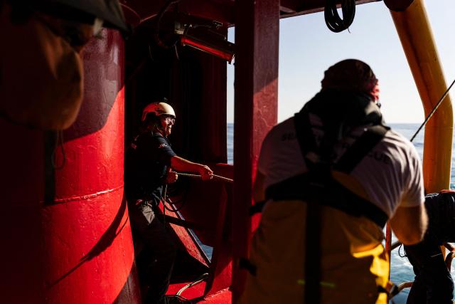 Crew members of the “Ocean Viking” rescue ship, operated by the French NGO SOS Mediterranee, take part in a team exercise to prepare for a rescue situation at sea with a "RHIB", an inflatable dinghy, on their way to the search-and-rescue zone in international waters in the Mediterranean Sea, on December 28, 2025. Migrants rescue ship "Ocean Viking" is preparing to return to operations following the attack it suffered on August 24, 2025 when Libyan Coast Guard forces fired directly on the rescue vessel operated by the NGO SOS Mediterranee. (Photo by Sameer Al-DOUMY / AFP)