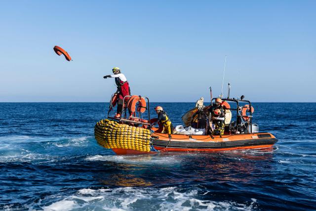 Crew members of the “Ocean Viking” rescue ship, operated by the French NGO SOS Mediterranee, take part in a team exercise to prepare for a rescue situation at sea with a "RHIB", an inflatable dinghy, on their way to the search-and-rescue zone in international waters in the Mediterranean Sea, on December 28, 2025. Migrants rescue ship "Ocean Viking" is preparing to return to operations following the attack it suffered on August 24, 2025 when Libyan Coast Guard forces fired directly on the rescue vessel operated by the NGO SOS Mediterranee. (Photo by Sameer Al-DOUMY / AFP)