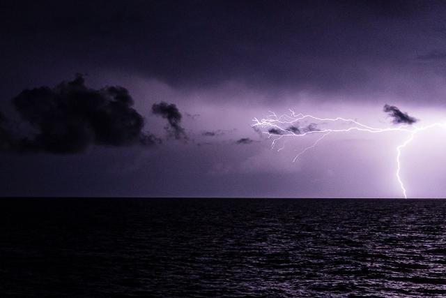 A lightning strikes over the Mediterranean Sea during a thunderstorm on December 29, 2025. (Photo by Sameer Al-DOUMY / AFP)